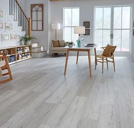 Bright dining room interior featuring light hardwood flooring and contemporary furniture.