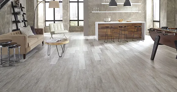 Spacious room featuring clean, light grey luxury vinyl plank flooring and modern decor.