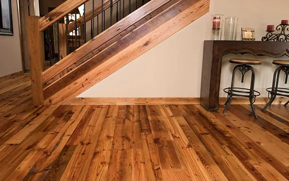 Rustic living area with natural wood laminate flooring and exposed wooden beams in Troy MI.