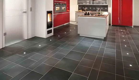 Modern kitchen with dark ceramic tile flooring and red cabinets in Ann Arbor MI.