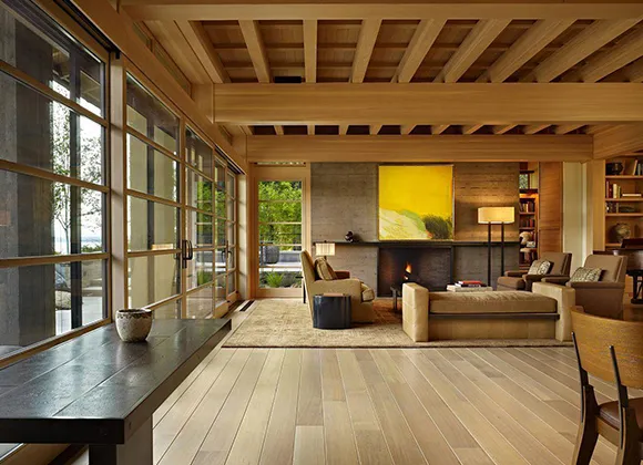Modern living area with large windows and custom laminate flooring design in Farmington Hills MI.