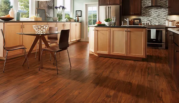 Bright kitchen and dining area with polished dark hardwood flooring in Troy MI home.