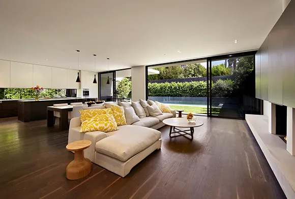 Spacious living room featuring light laminate flooring and stylish modern sofa.